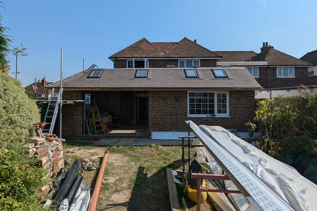 Extension shell with roof covering and openings for glazing