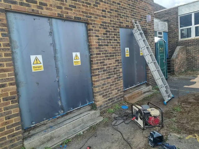 Steel security panels fitted over openings in a brick building