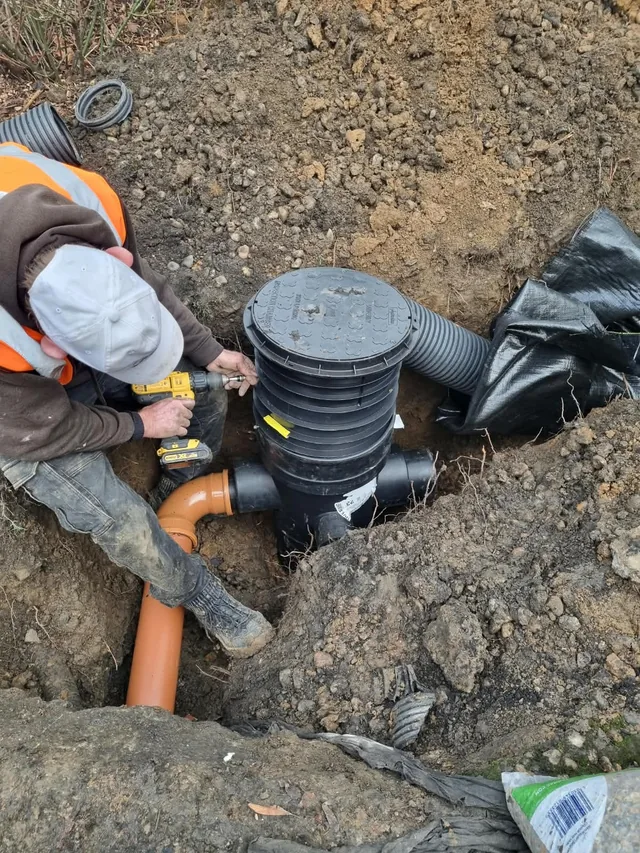 A new plastic inspection chamber being connected to drainage pipes