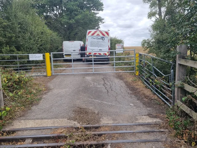 Metal access gate between yellow posts at a site entrance