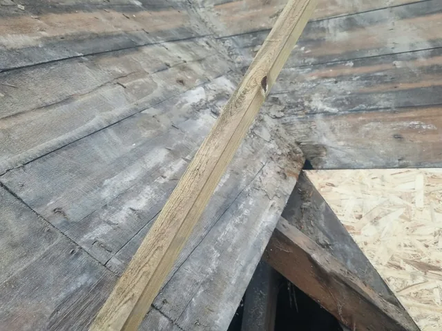 Uncovered timber boarding at the junction between roof slopes