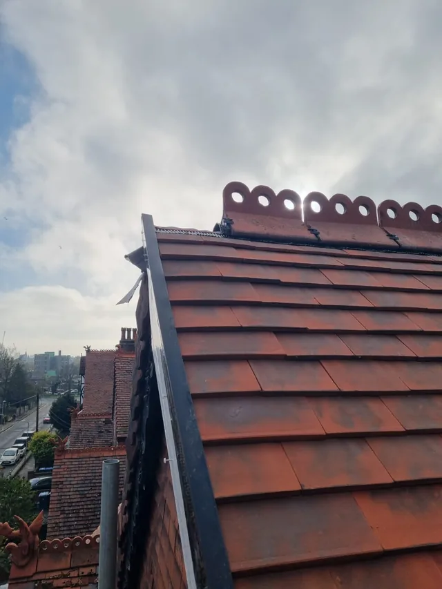 Decorative ridge tiles above the red tiled roof