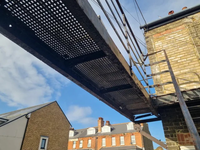 Underside of a large steel landing and its supporting structure