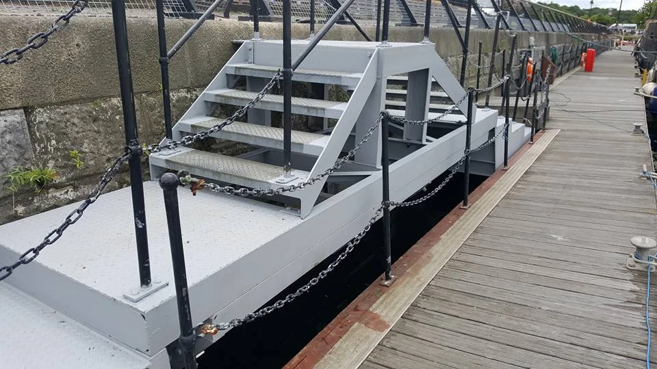 Fabricated steel stairs, handrails and access platform beside a pontoon